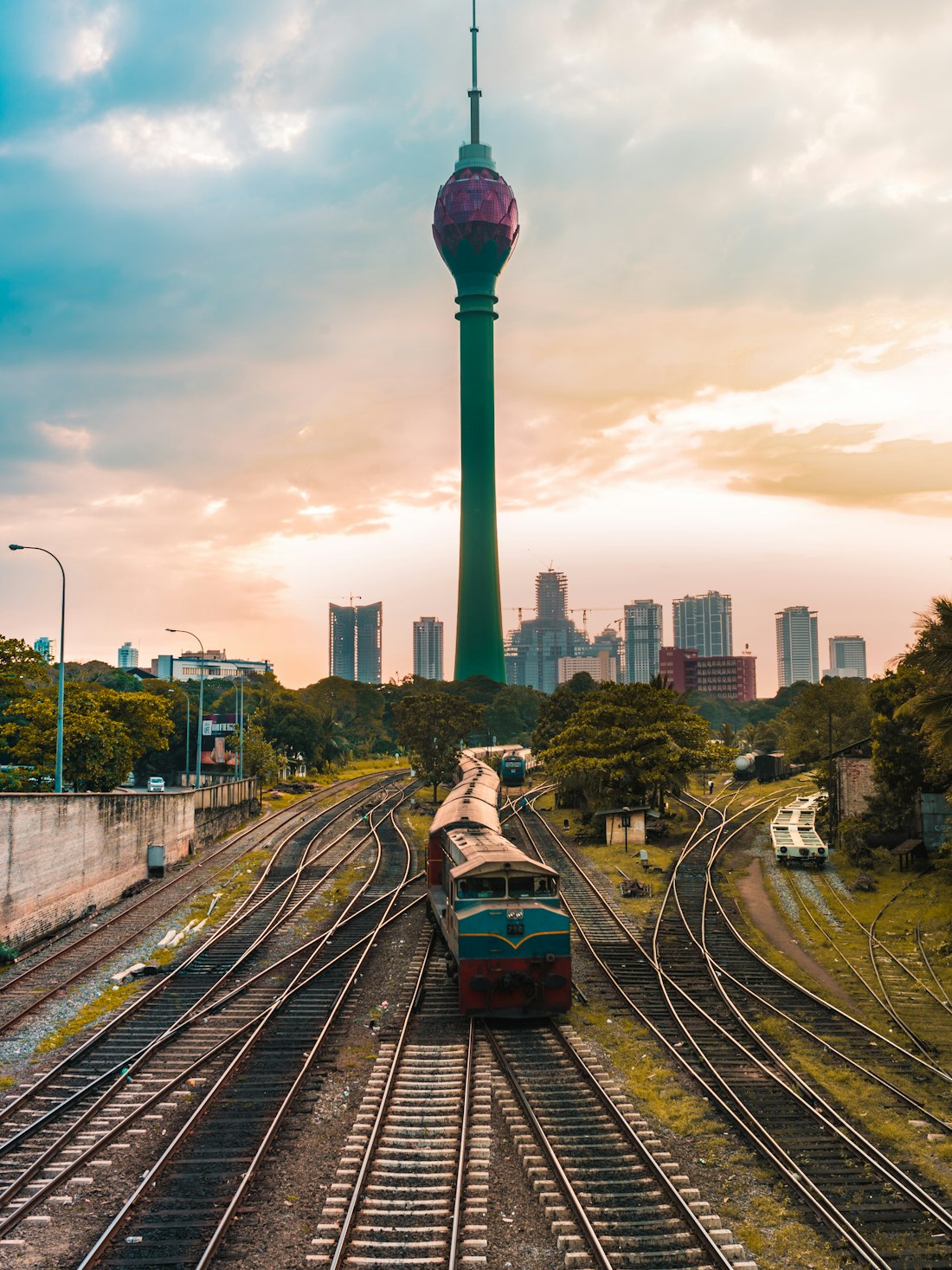 Railway tracks running toward the Lotus Tower in Colombo at golden hour